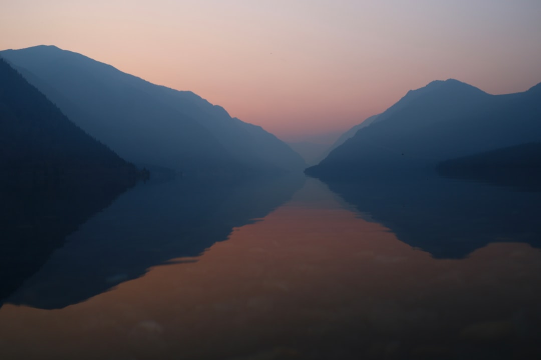 A body of water with mountains in the background