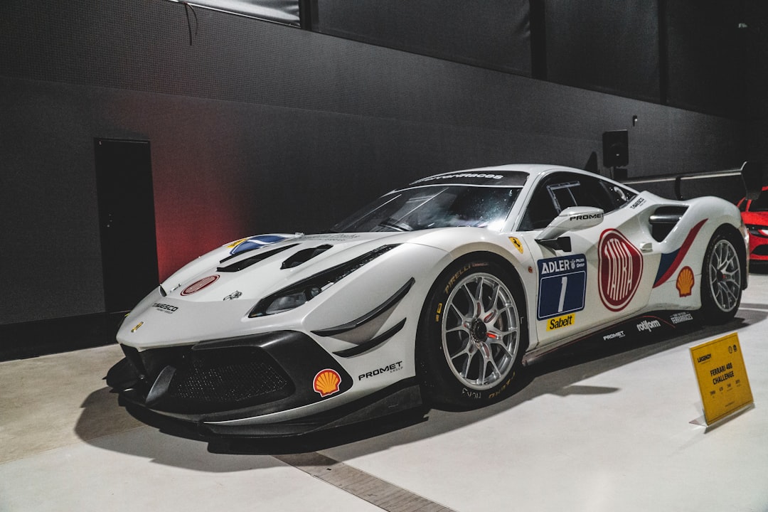 a white sports car on display in a building